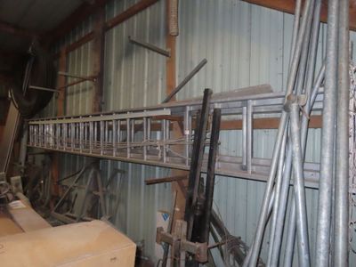 a long metal shelf with a bunch of tools on it