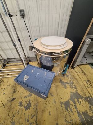 an image of a bucket with a lid on a wooden floor