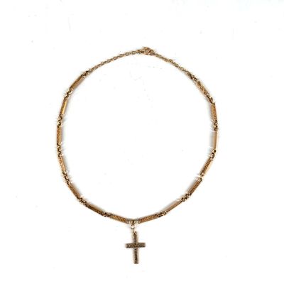 a close up of a necklace with a cross on it
