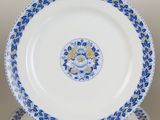 three blue and white plates with flowers on them sitting on a table