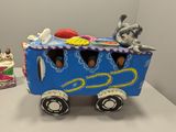 a toy train with people on it on a table