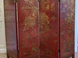 a red room divider with oriental designs on it
