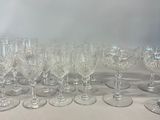 a lot of wine glasses sitting on a table