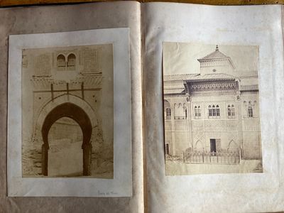 an old photo of a book opened to show a picture of a building