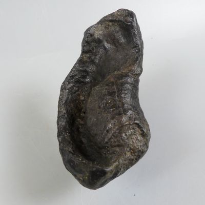 a close up of a piece of metal on a white surface