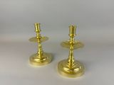 pair of brass candlesticks on a white background