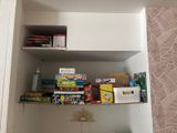 a shelf that has a lot of books on it