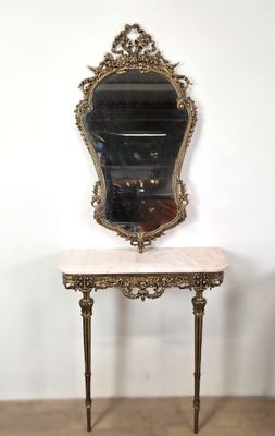 an ornately decorated table with a mirror on top of it