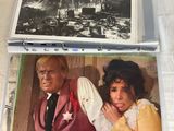 two movie posters of a man and a woman are on a table