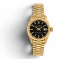 une montre Rolex en or avec un cadran noir sur fond blanc