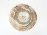 a brown and white bowl on a white surface