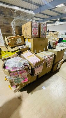 a large amount of boxes stacked on top of each other in a warehouse