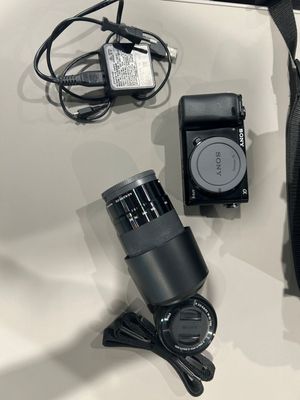 a camera and other electronics laid out on a table