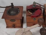 two old coffee grinders on a marble counter top