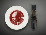 a plate with a picture of a man on it next to a knife