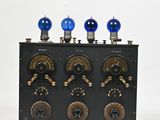 an image of a black and gold clock with four blue lights