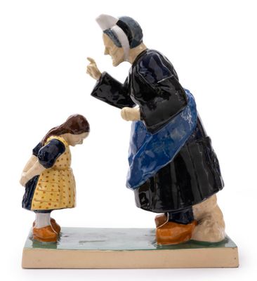 figurine of a woman with a child in a yellow dress