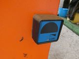 an orange wall with a blue and black sign on it