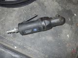 a drill on the floor next to a hose