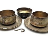 three cups and saucers sitting on a plate