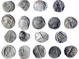 some silver coins are shown on a white surface