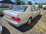 a silver car parked in a parking lot with other cars