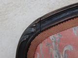 a close up of a chair with a pink seat and back