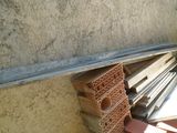 a pile of wood sitting on the ground next to a building