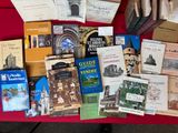 many books on a red table with a red table cloth