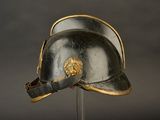a helmet on a stand with a lion head on it
