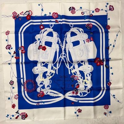 a close up of a blue and white square with a pair of shoes on it
