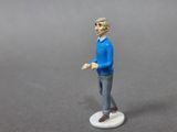 a figurine of a man standing on a white base