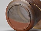 a close up of a brown vase with a brown lid
