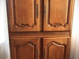 a wooden cabinet that is sitting on a wooden floor