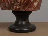 a marble vase sitting on top of a wooden table