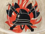 a fireman ' s helmet on display with flames in the background