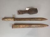 two old knives and a knife sharpe on a white surface