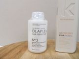 a bottle of olaplex and a bottle of blow dryer on a table