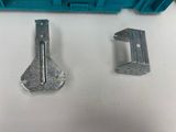two pieces of metal are sitting on a table next to each other