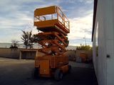 a picture of a yellow scissor is parked in a parking lot