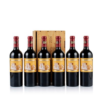 four bottles of red wine in front of a wooden box