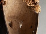 an old wooden shoe with a rope on top of it