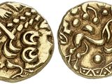 a close up of two gold coins with arabic writing on them