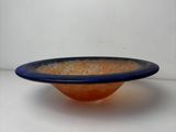 a blue and orange bowl sitting on a white table