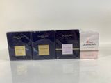 three boxes of perfume sitting on top of a white table