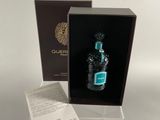 an image of a bottle of perfume in a box on a table