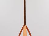 a close up of a guitar on a stand on a white background