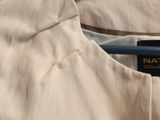 the back of a shirt hanging on a hanger on a wall