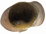 a brown hat with holes in it on a white surface