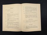an open book on a black table with a black background
